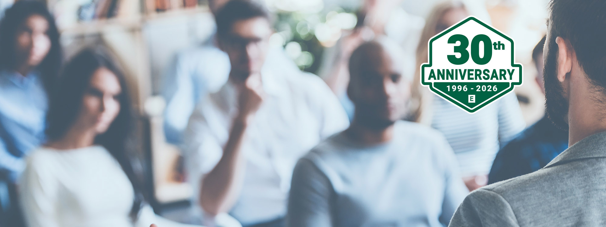 Backshot of man facing seated audience
